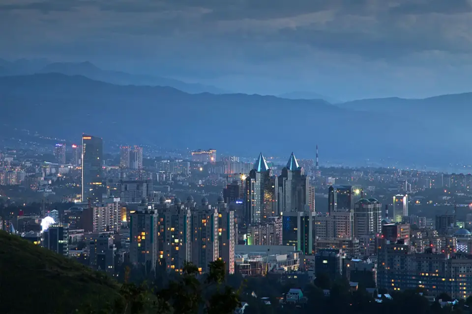 Almaty at night beneath the Tien Shan mountains