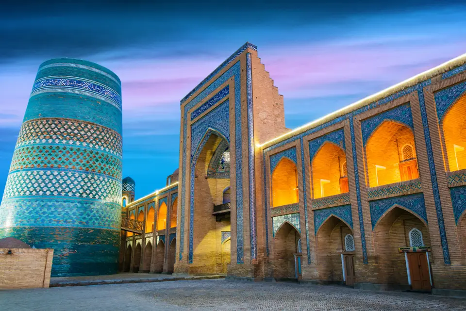 Kalta Minor minaret and the Muhammad Amin Khan madrasah lit at blue hour